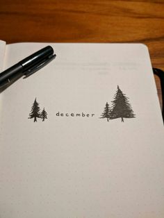 a pen is sitting on top of a notebook with the word december written in it