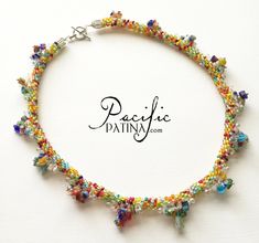 a multicolored beaded necklace is displayed on a white background with the words pacific dainty com