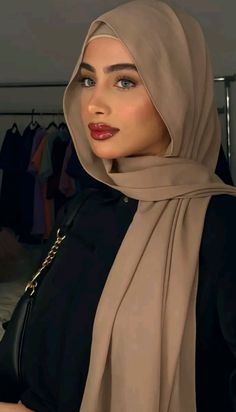 a woman wearing a hijab and black shirt