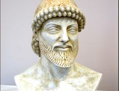 a statue of a man with a beard and wearing a headdress is shown