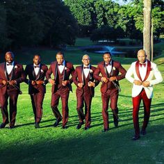 a group of men in tuxedos standing next to each other on a field