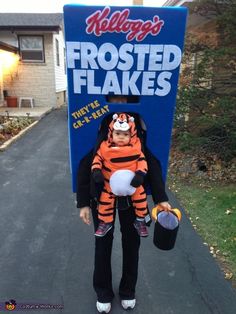 a woman in a tiger costume holding a baby wearing a life jacket and an animal hat