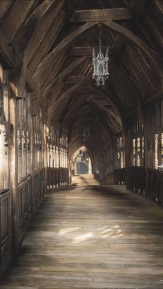 the inside of an old wooden building with chandelier hanging from it's ceiling