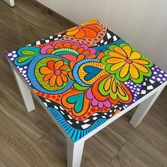 an artistically painted stool sits on the floor