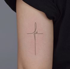 a small cross tattoo on the left side of the right arm, with one line drawn across it