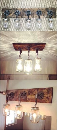 three mason jars are hanging from the ceiling above a vanity mirror and light fixture in a bathroom