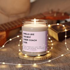 a candle sitting on top of a table next to a string of lights and a guitar