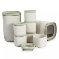 a group of white dishes and cups sitting next to each other