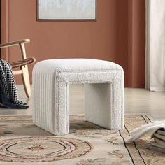 a white bench sitting on top of a rug