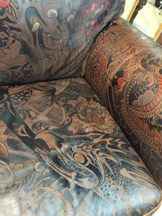 an upholstered chair with tattoos on it