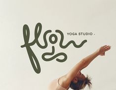 a woman is doing yoga in front of a wall with the words yoga studio on it