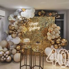 a room filled with balloons and a table