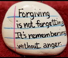 a rock with writing on it that says, forging is not forgeting it's remending without anger