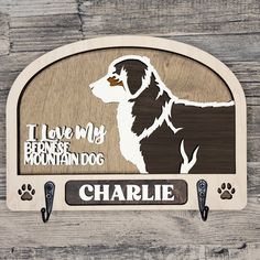 a wooden sign that says i love my bernese mountain dog with a black and white dog on it