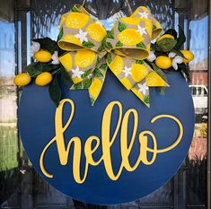 a blue door with a yellow bow and the word hello painted on it