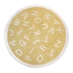 a yellow and white round rug with words written on it