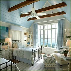 a bedroom with blue walls and ceiling fan