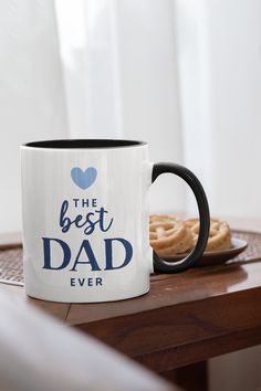 the best dad ever coffee mug with pretzels in front of it on a table