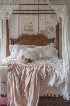 a bed with white sheets and pink flowers on the headboard is in front of a window