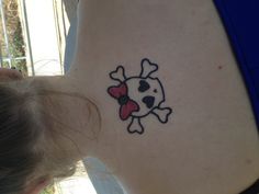 a woman with a skull and bow tattoo on her back