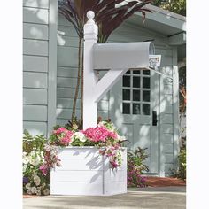 a white mailbox with pink flowers in it