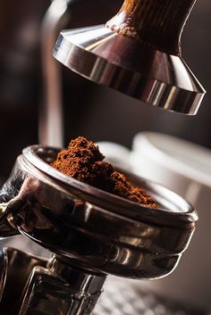 a coffee grinder filled with ground coffee