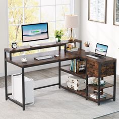 a computer desk with two computers on it