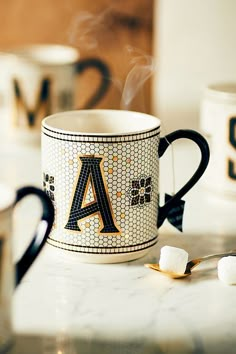 a coffee mug sitting on top of a counter with marshmallows