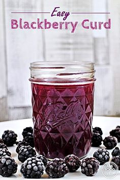 blackberry curd in a mason jar surrounded by blackberries on a white surface with text overlay