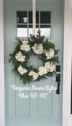 a blue front door with a wreath on it