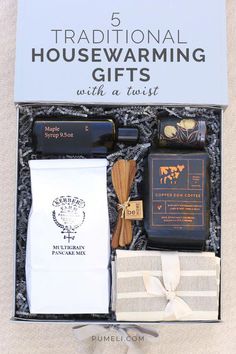 the 5 traditional housewarming gifts with a twist are in a gift box, including an envelope and ribbon