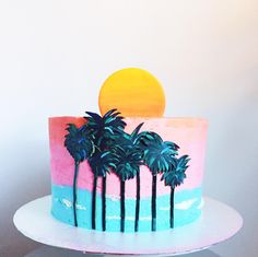 a cake decorated with palm trees and the sun