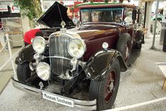 an antique car on display in a museum