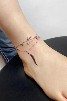 a woman's foot with a tattoo on it and an arrow in the middle