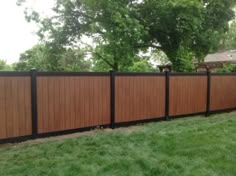 a wooden fence in the middle of a yard