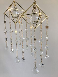 a gold chandelier with crystal beads hanging from it's sides and starbursts