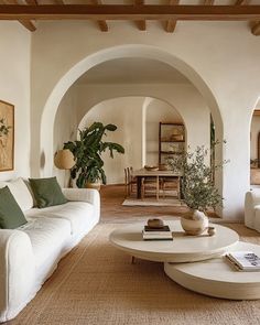 a living room filled with furniture and plants