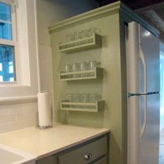 a refrigerator freezer sitting inside of a kitchen next to a sink