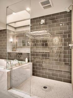 a bathroom with a walk in shower next to a bath tub