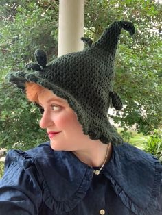 a woman wearing a green crocheted hat