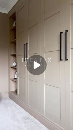 an empty room with some cabinets and shelves on the wall, in front of a white carpeted floor