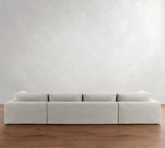 a white couch sitting on top of a wooden floor