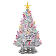 a silver christmas tree with multicolored lights on it's top and a star