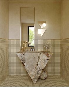 a bathroom with a marble sink and mirror