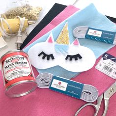 sewing supplies including scissors, thread, and other crafting items are laid out on a table