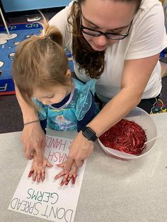 a woman teaching a child how to do crafts