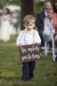 a little boy holding a sign that says, has anybody seen the ring?