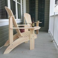 a wooden rocking chair sitting on top of a porch next to a bottle of beer