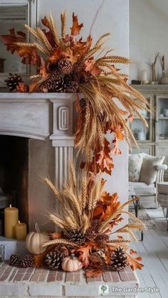 a fireplace decorated with autumn leaves and pine cones