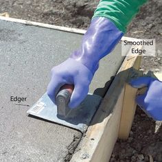 a person in blue gloves is using a hammer